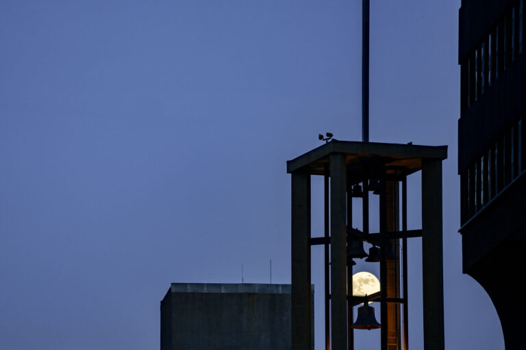 Full moon rising behind church bells 1 A full moon rising behind church bells in Downtown Minneapolis.
