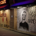 Boards reading "Say His Name" "Justice" and a drawing of George Floyd on Stella's Fish Cafe windows on Lake Street in Uptown Minneapolis. June 2020