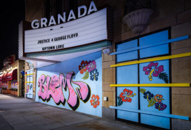 The Granada Theatre in Uptown Minneapolis with painted boards on the windows. The marquee reading “Justice 4 George Floyd” “Uptown Love”.