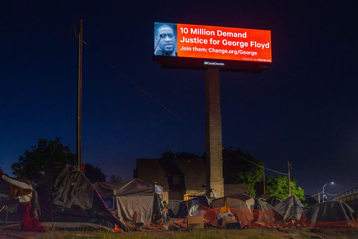 George Floyd billboard above an encampment in June 2020.