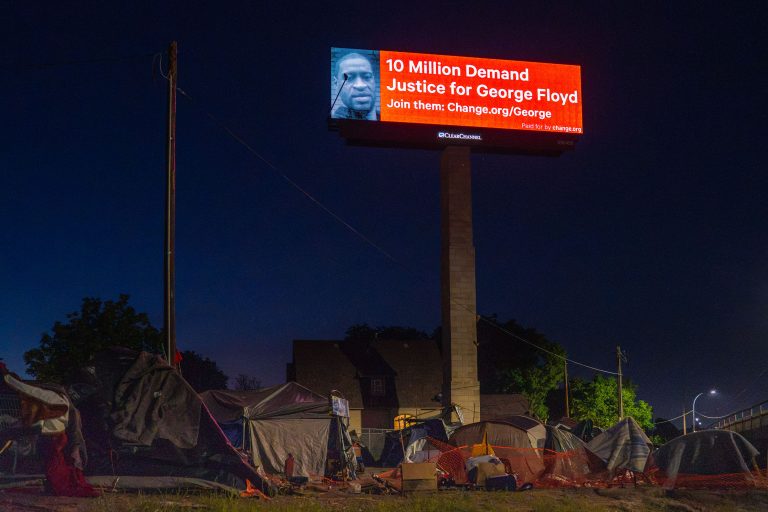 Justice For George Floyd billboard in Minneapolis 4 George Floyd billboard above an encampment in June 2020.