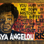 A mural on the side of Calhoun Square mall with a quote by Maya Angelou:“You may write me down in history with your bitter twisted lies, you may trod me in the very dirt, but still like dust, I’ll rise”
