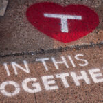 Stencil art placed by the Metro Transit outside their building in the North Loop. “In this together”