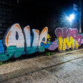 Graffiti that reads "Love Hope Unity" on the side of a building in uptown.