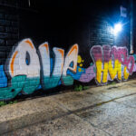 Graffiti that reads "Love Hope Unity" on the side of a building in uptown.