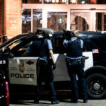 Officers point their guns at open windows at the Sheraton Hotel. The police had responded to reports of a fire inside as squatters took over.