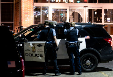 Officers point their guns at open windows at the Sheraton Hotel. The police had responded to reports of a fire inside as squatters took over.