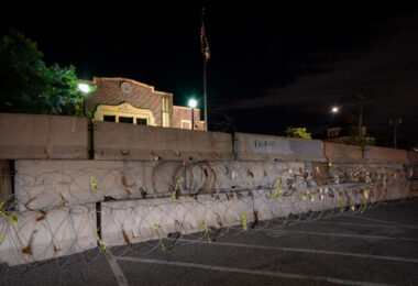 Minneapolis Police Department Second Precinct in Northeast Minneapolis behind razor wire and concrete barricades.