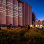 Projection on the Gold Medal Flour concrete elevators near downtown Minneapolis.“Revolution Will Be Televised”