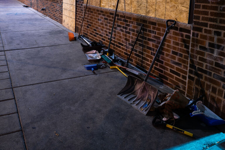 Community cleanup 3 Brooms and shovels on the side of a building for community cleanup of damaged buildings during civil unrest in Minneapolis.
