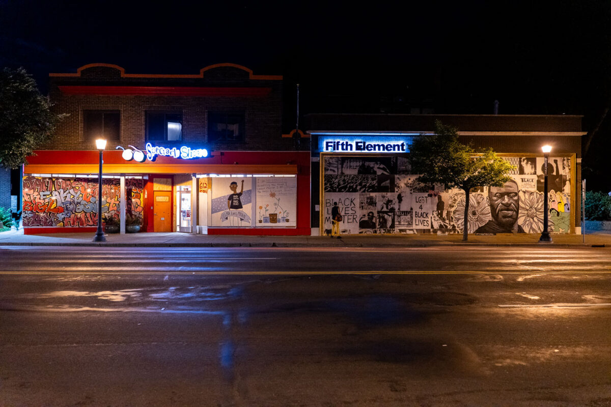 Spectacle Shoppe and Fifth Element on Hennepin Avenue with boards on it following the murder of George Floyd.