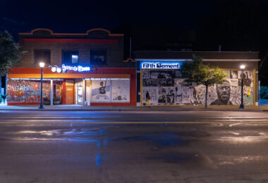 Spectacle Shoppe and Fifth Element on Hennepin Avenue with boards on it following the murder of George Floyd.