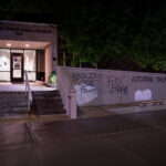 Graffiti on the Hennepin County Medical Examiner building near downtown Minneapolis. Graffiti reads “Abolish the police” and “AutoZone them again” (referring to the burning of the AutoZone building that was the first building burned during 2020 riots).