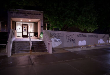 Graffiti on the Hennepin County Medical Examiner building near downtown Minneapolis. Graffiti reads “Abolish the police” and “AutoZone them again” (referring to the burning of the AutoZone building that was the first building burned during 2020 riots).