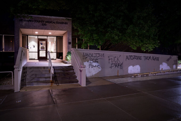 Autozone Them Again and Abolish The Police 1 Graffiti on the Hennepin County Medical Examiner building near downtown Minneapolis. Graffiti reads “Abolish the police” and “AutoZone them again” (referring to the burning of the AutoZone building that was the first building burned during 2020 riots).