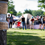 Signs on a tree located near the entrance to the Powderhorn East homeless encampment in South Minneapolis. The encampment was cleared by Minneapolis Police on July 21, 2020.