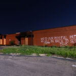 Graffiti on the damaged Lake Street Station post office. “We love our postal patrons! We WILL be back to serve you!”