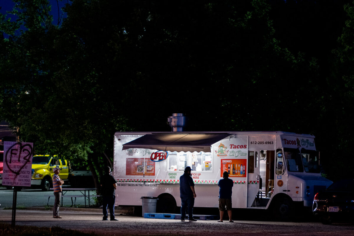 People social distancing in line at a taco food truck on Lake Street.=