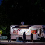 Tacos on Lake Street 3 People social distancing in line at a taco food truck on Lake Street.=