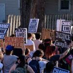 Change the Council 3 Protesters holding up signs reading “Change the council” “Justice for George Floyd” during the “How many weren’t filmed?” March through Uptown Minneapolis.
