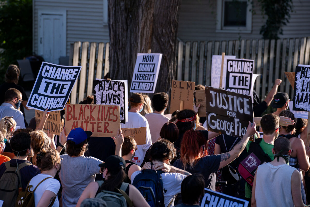 Protesters holding up signs reading “Change the council” “Justice for George Floyd” during the “How many weren’t filmed?” March through Uptown Minneapolis.