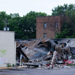The rubble of the O'Reilly Auto Parts store on Nicollet Avenue. The store was burned after the May 25th, 2020 death of George Floyd.ACAB, Fuck Jacob Frey, Fuck 12, RIP George and Riots work written on the remaining wall