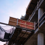 Construction site in downtown Minneapolis with wood that reads “Stay happy stay safe”.