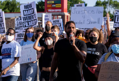 Toussaint Morrison leads the “How many weren’t filmed?” March down Hennepin Ave in Uptown Minneapolis.