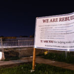 A sign constructed on Minnehaha Ave by Wellington Management stating their intent to rebuild. This block suffered substantial arson damage during unrest.