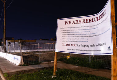 A sign constructed on Minnehaha Ave by Wellington Management stating their intent to rebuild. This block suffered substantial arson damage during unrest.