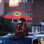Woman with an Oromo flag during a march through Northeast Minneapolis.