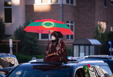 Woman with an Oromo flag during a march through Northeast Minneapolis.