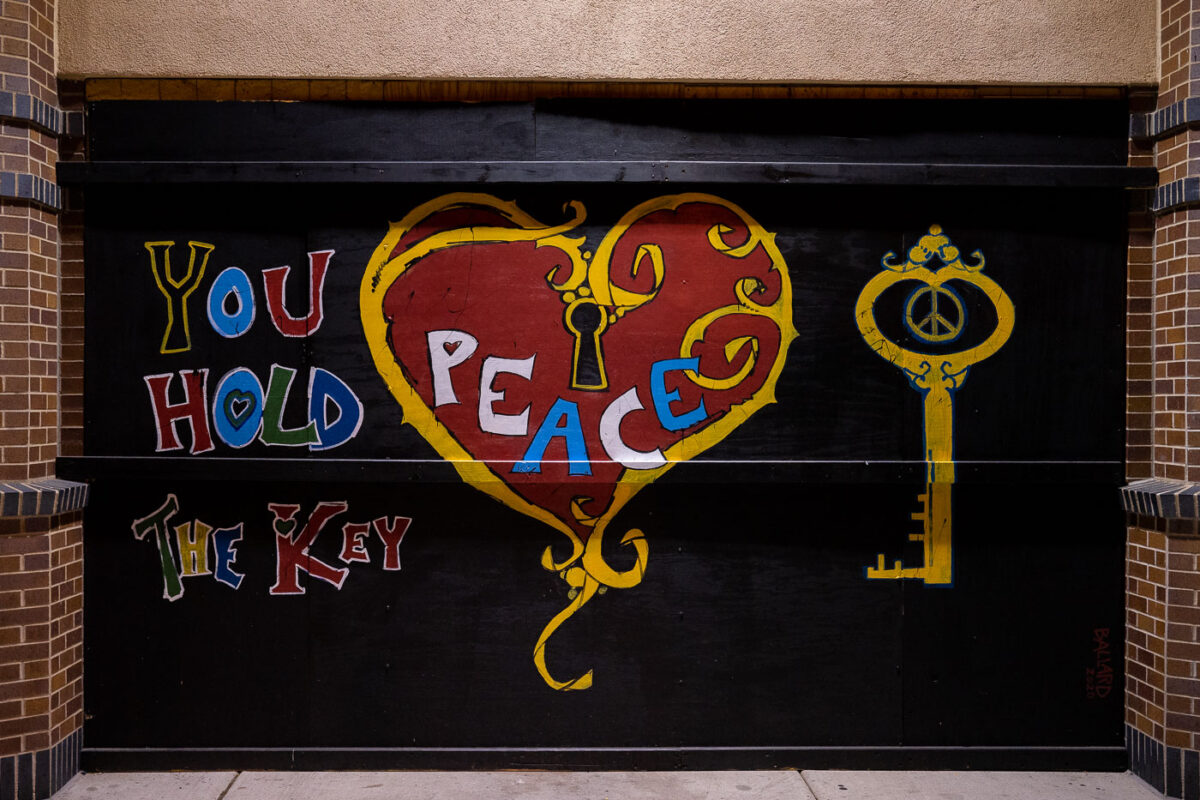 Painted boards on the CVS on Lake Street in Uptown Minneapolis. “You hold the key” “Peace”