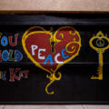 Painted boards on the CVS on Lake Street in Uptown Minneapolis. “You hold the key” “Peace”