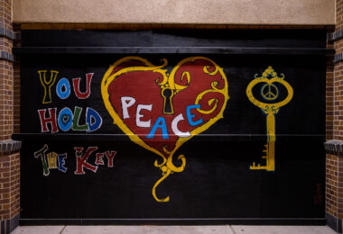 Painted boards on the CVS on Lake Street in Uptown Minneapolis. “You hold the key” “Peace”
