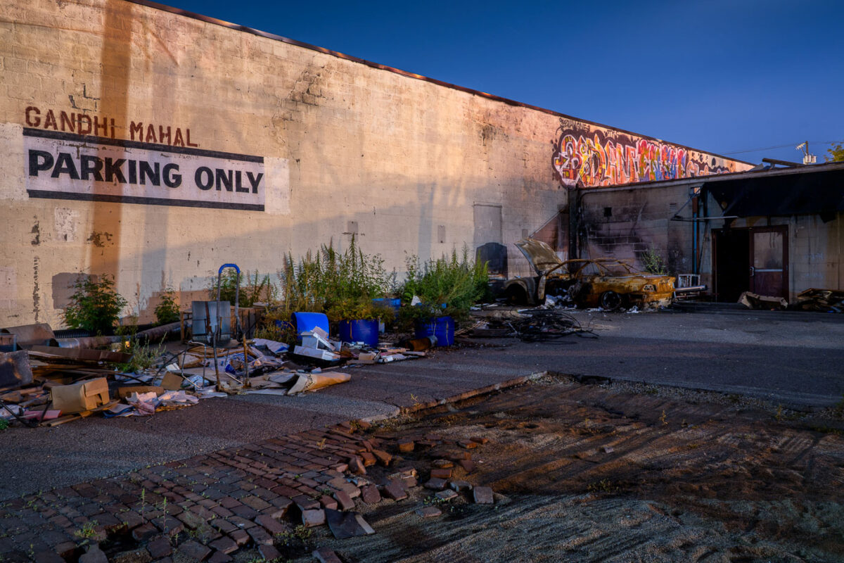 Burned out car in the parking lot for Gandhi Mahal restaurant in South Minneapolis. Buildings were destroyed during the unrest following the May 25th death of George Floyd.