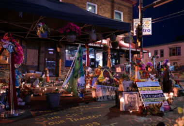 The George Floyd Memorial at George Floyd Square with lit candles.