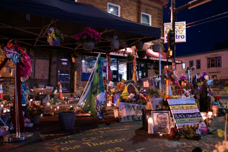 Flowers and candles lit at the George Floyd Memorial 4 The George Floyd Memorial at George Floyd Square with lit candles.