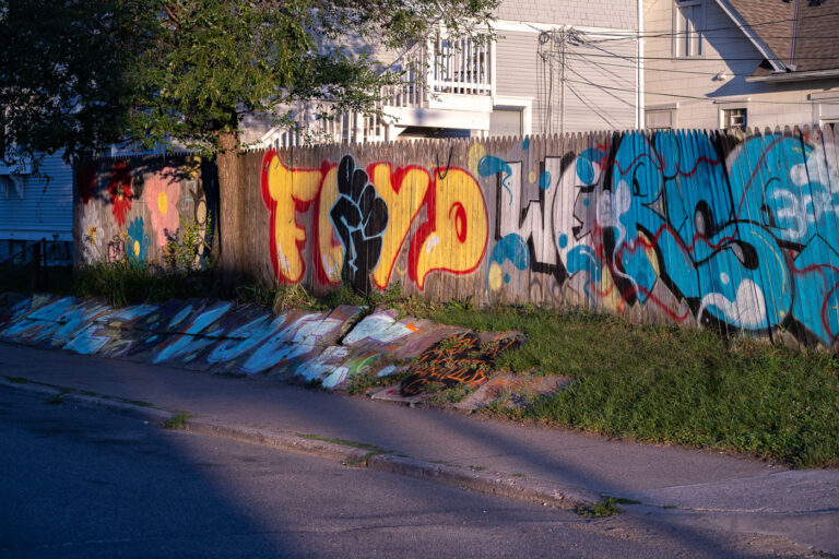 George Floyd Rising Fist Graffiti On 38th Street 1 George Floyd graffiti on a fence on 38th Street in George Floyd Square.