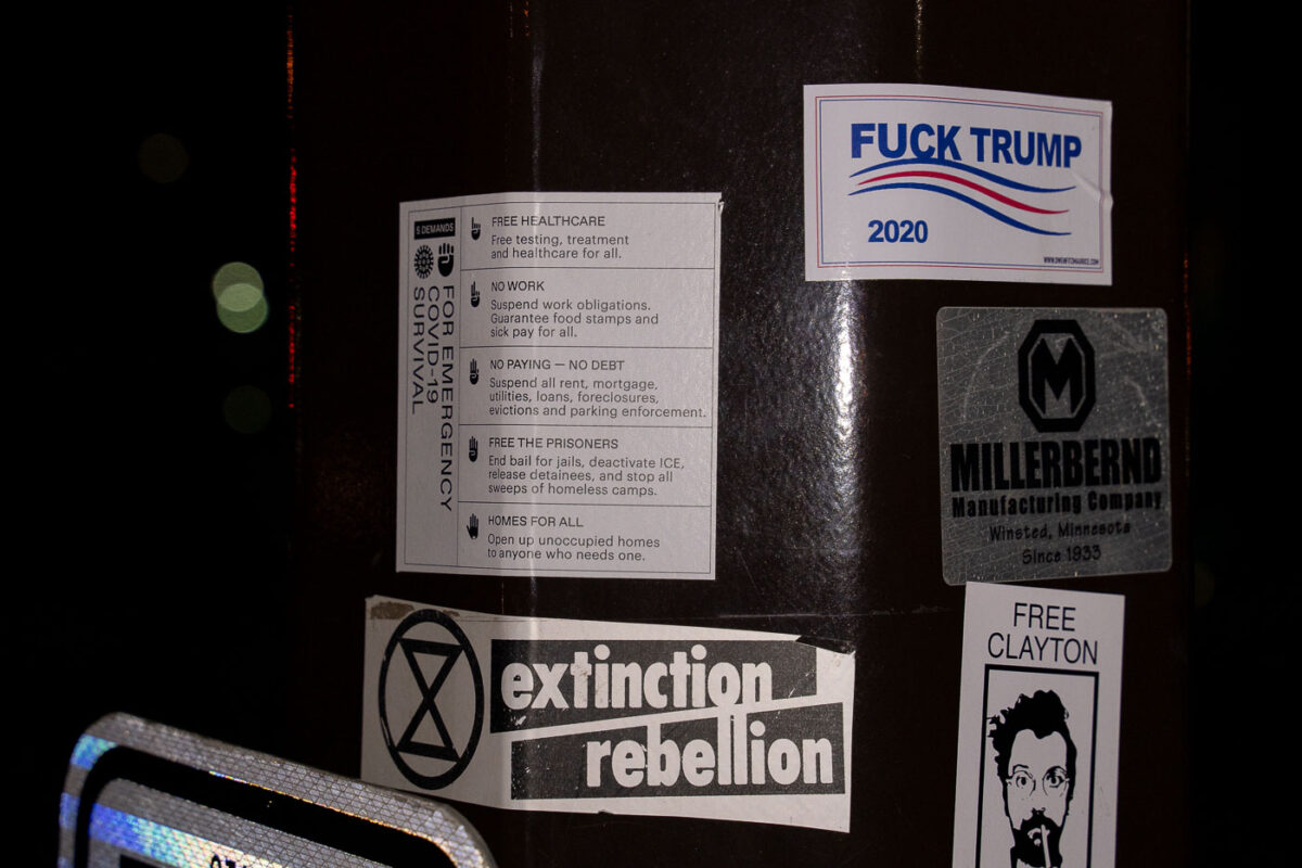 Stickers on a street pole in Minneapolis. Extinction Rebellion and Fuck Trump 2020.