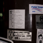 Stickers on a street pole in Minneapolis. Extinction Rebellion and Fuck Trump 2020.
