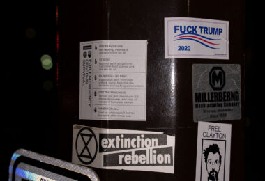 Stickers on a street pole in Minneapolis. Extinction Rebellion and Fuck Trump 2020.