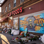 The George Floyd mural at George Floyd Square with flowers on August 17, 2020.
