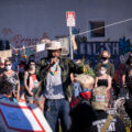 George Floyd Square garden caretaker Jay Webb speaks with those gathered at a rally at George Floyd Square on the day that President Trump was in town.