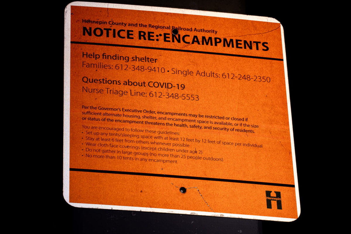 Notice about encampments and COVID-19 posted on the Midtown Greenway in Minneapolis seen on August 10, 2020.