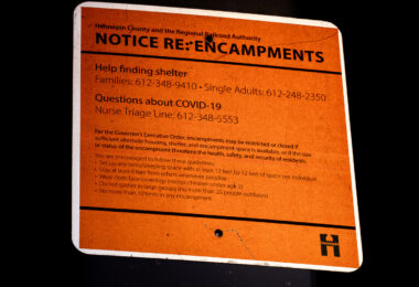 Notice about encampments and COVID-19 posted on the Midtown Greenway in Minneapolis seen on August 10, 2020.