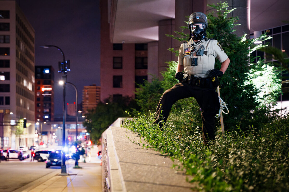 Hennepin County Sheriffs Officer with a gas mask on outside the Hennepin County Jail in downtown Minneapolis.