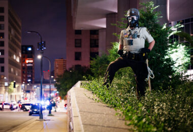 Hennepin County Sheriffs Officer with a gas mask on outside the Hennepin County Jail in downtown Minneapolis.