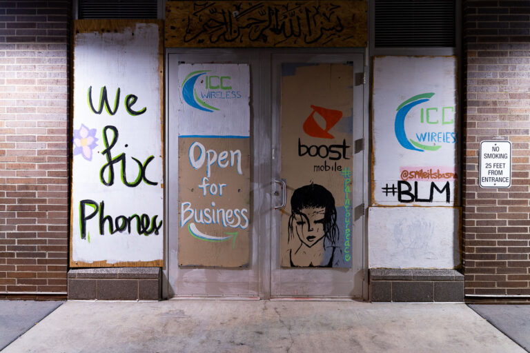 ICC Wireless Boost Mobile graffiti boards 3 Cell phone store open for business with boards on the windows.