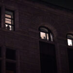 Inmates inside the City Hall Jail look down on protesters outside who are playing music and asking for their release.